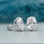Pair of oval stud earrings with double prong setting