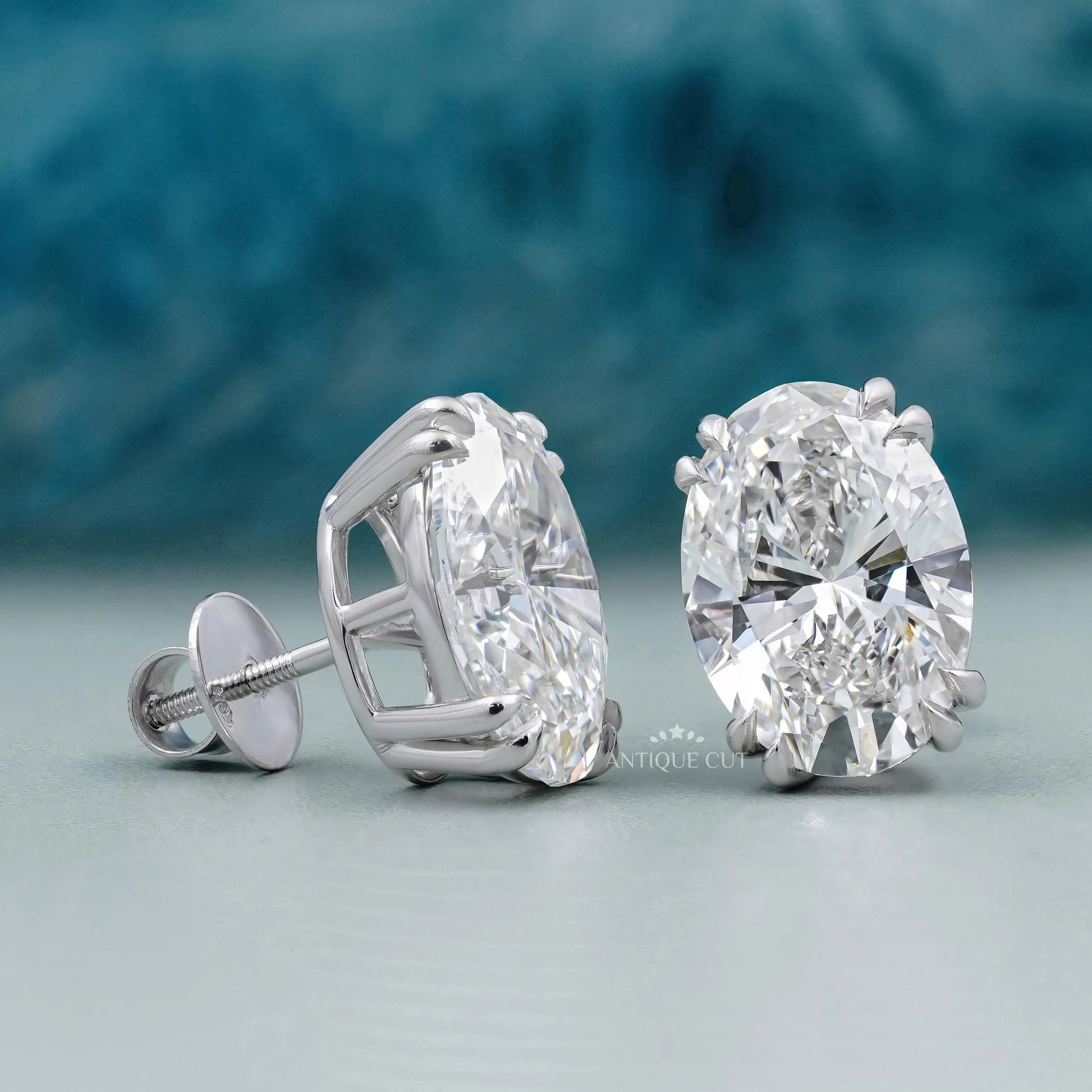 Front view of oval diamond stud earrings with claw double prongs