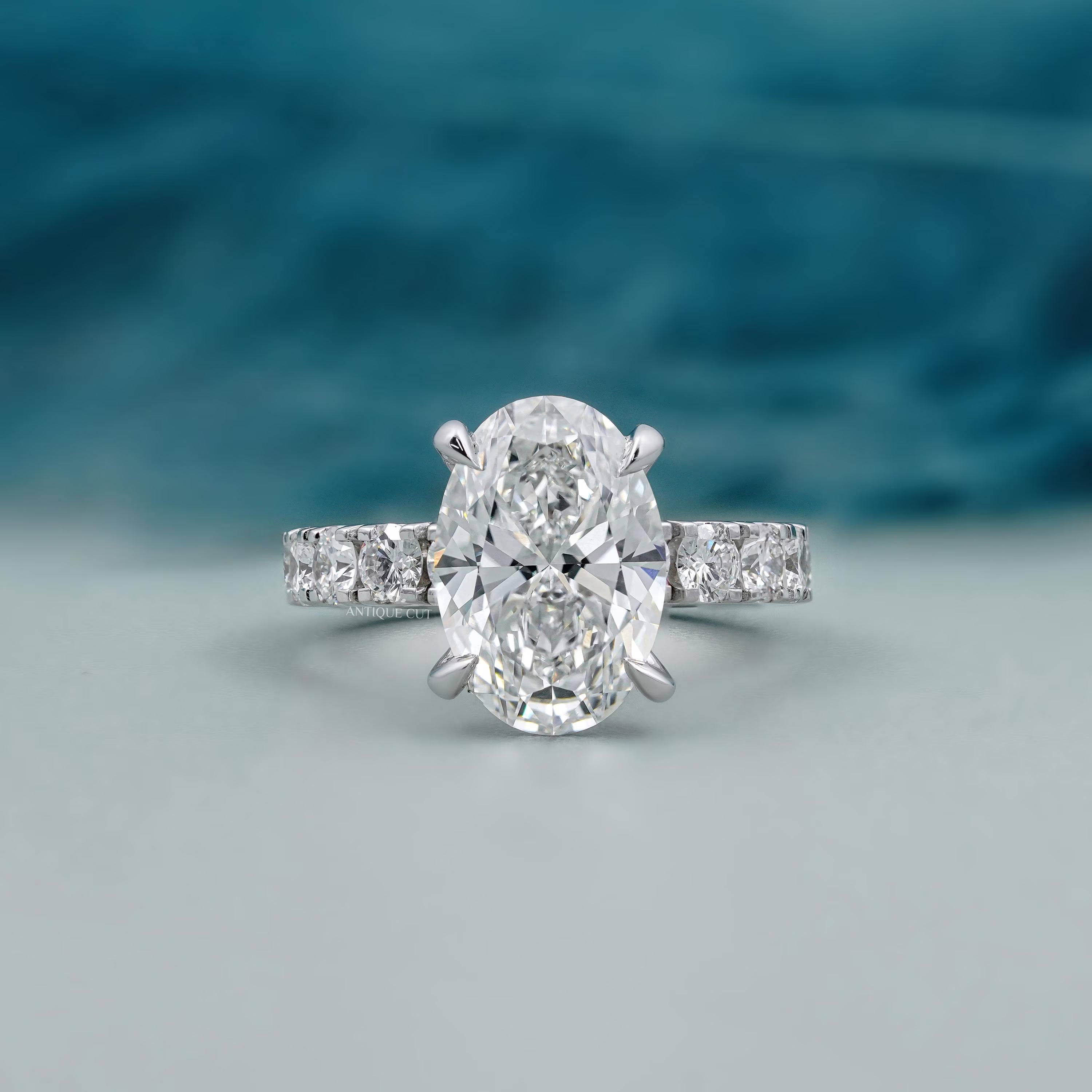 Oval diamond bridal ring with diamond accented band