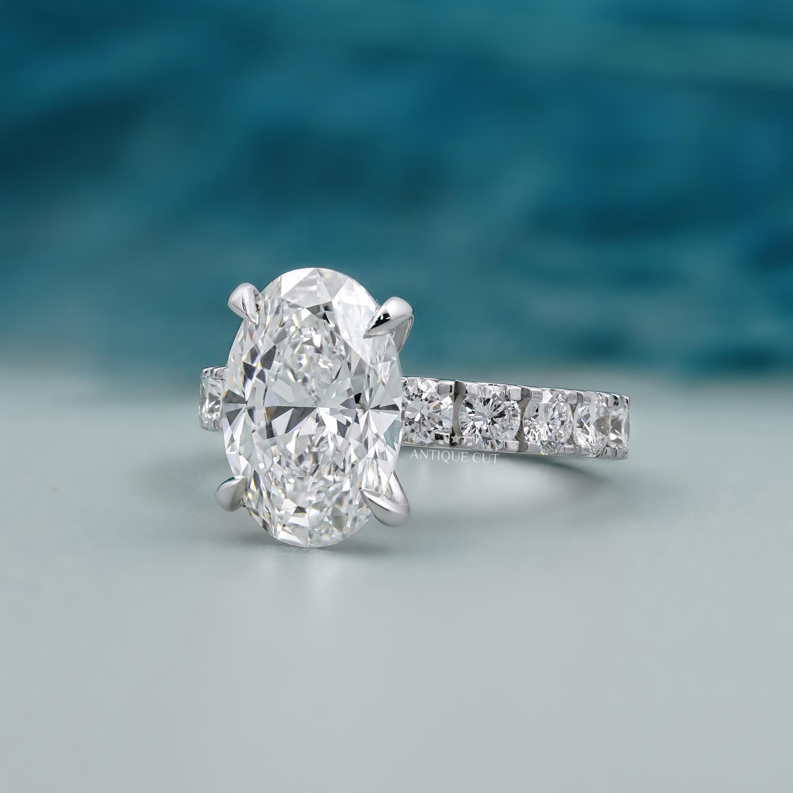 Oval solitaire diamond ring with white gold pave diamond band