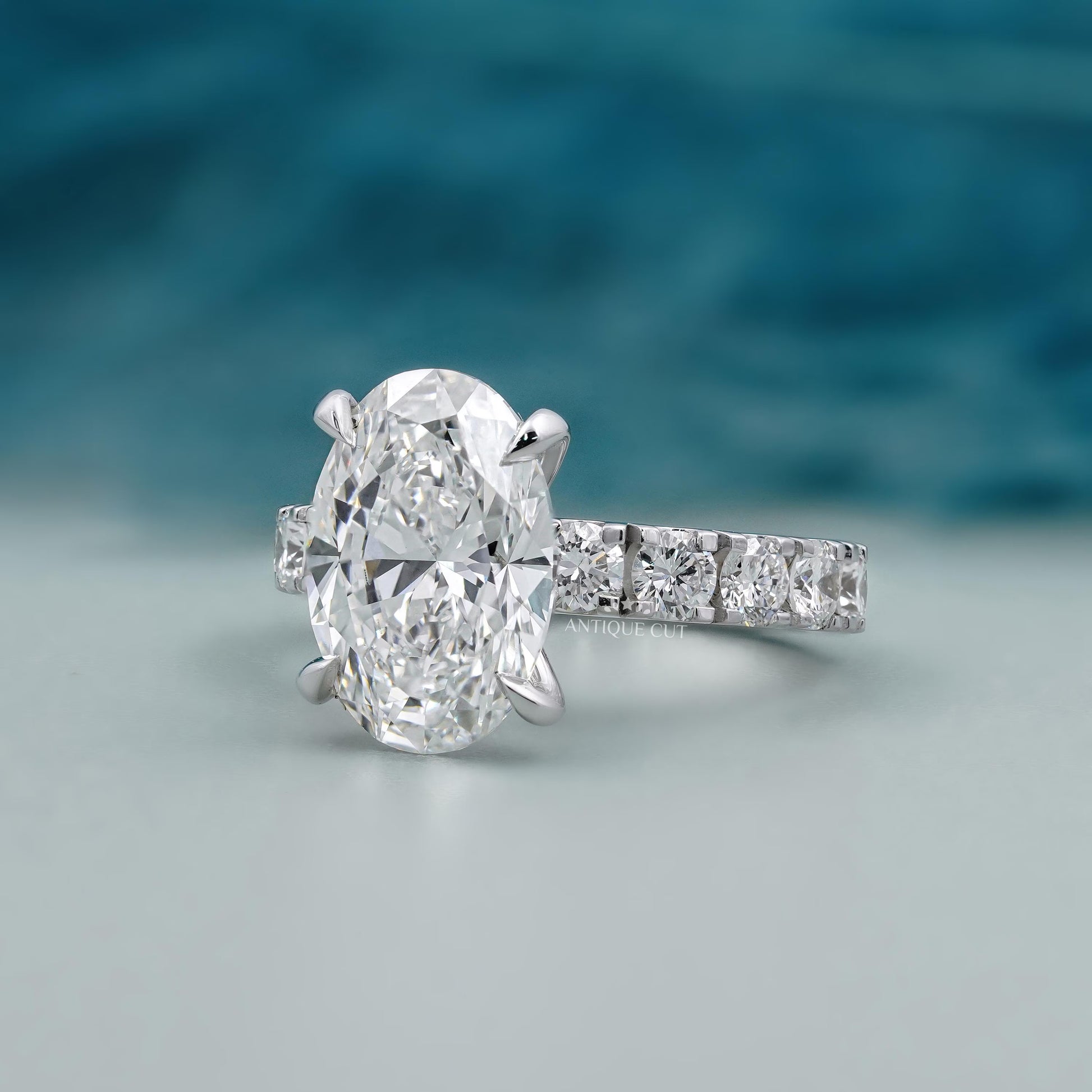 Oval solitaire diamond ring with white gold pave diamond band