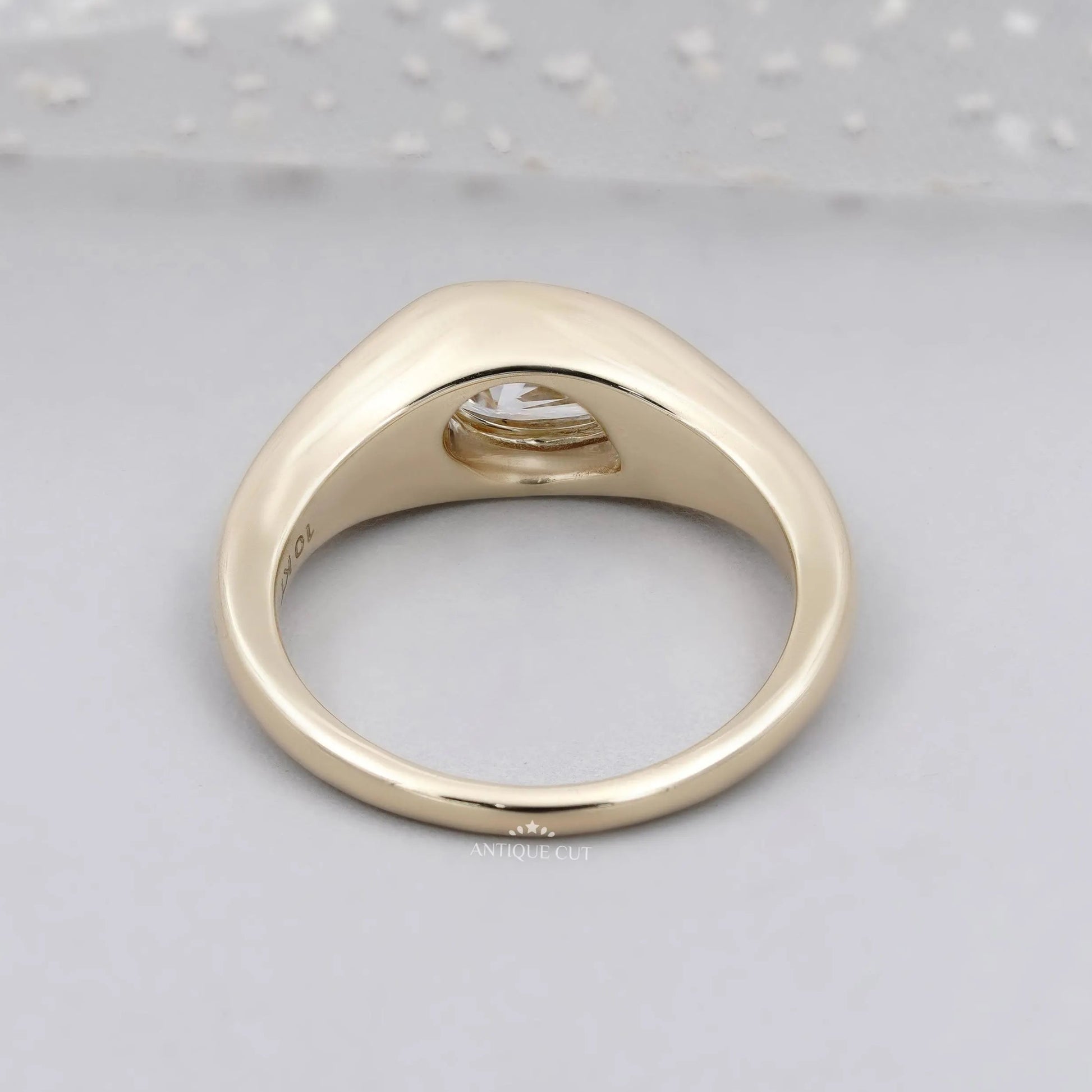 Low profile pear diamond ring shown from the front