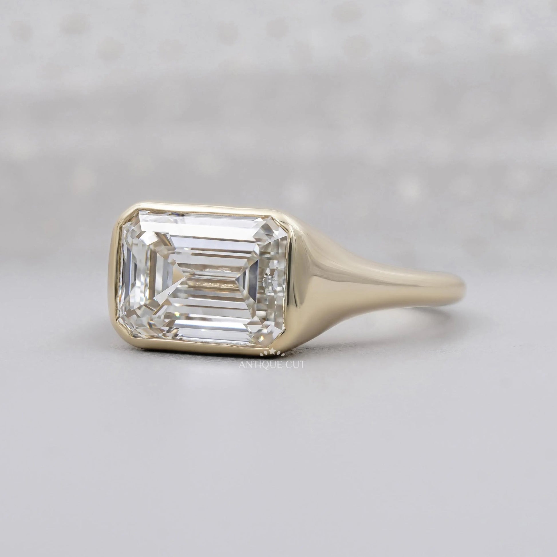 East West emerald cut diamond bezel signet ring design