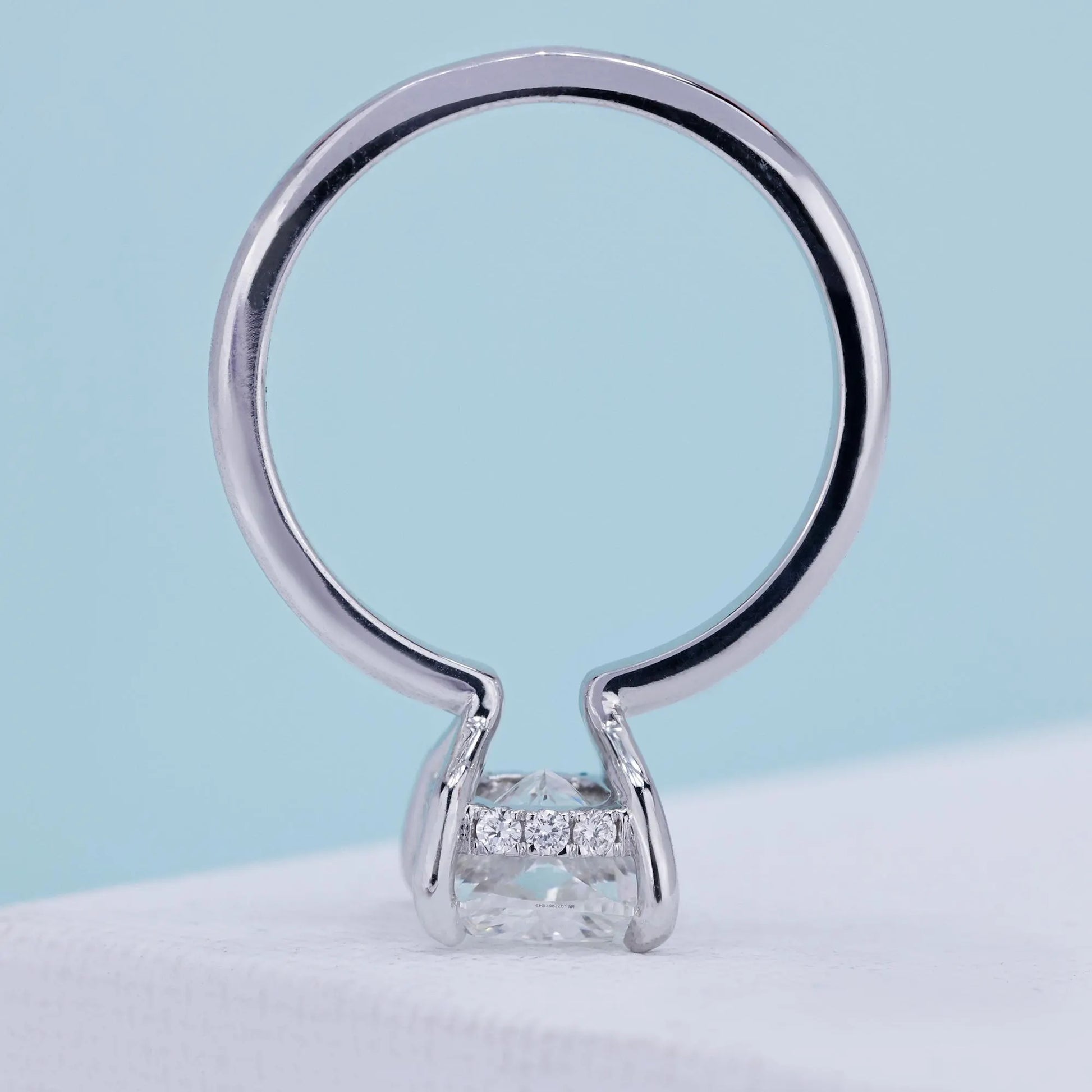 Cushion solitaire diamond ring with hidden halo accent design
