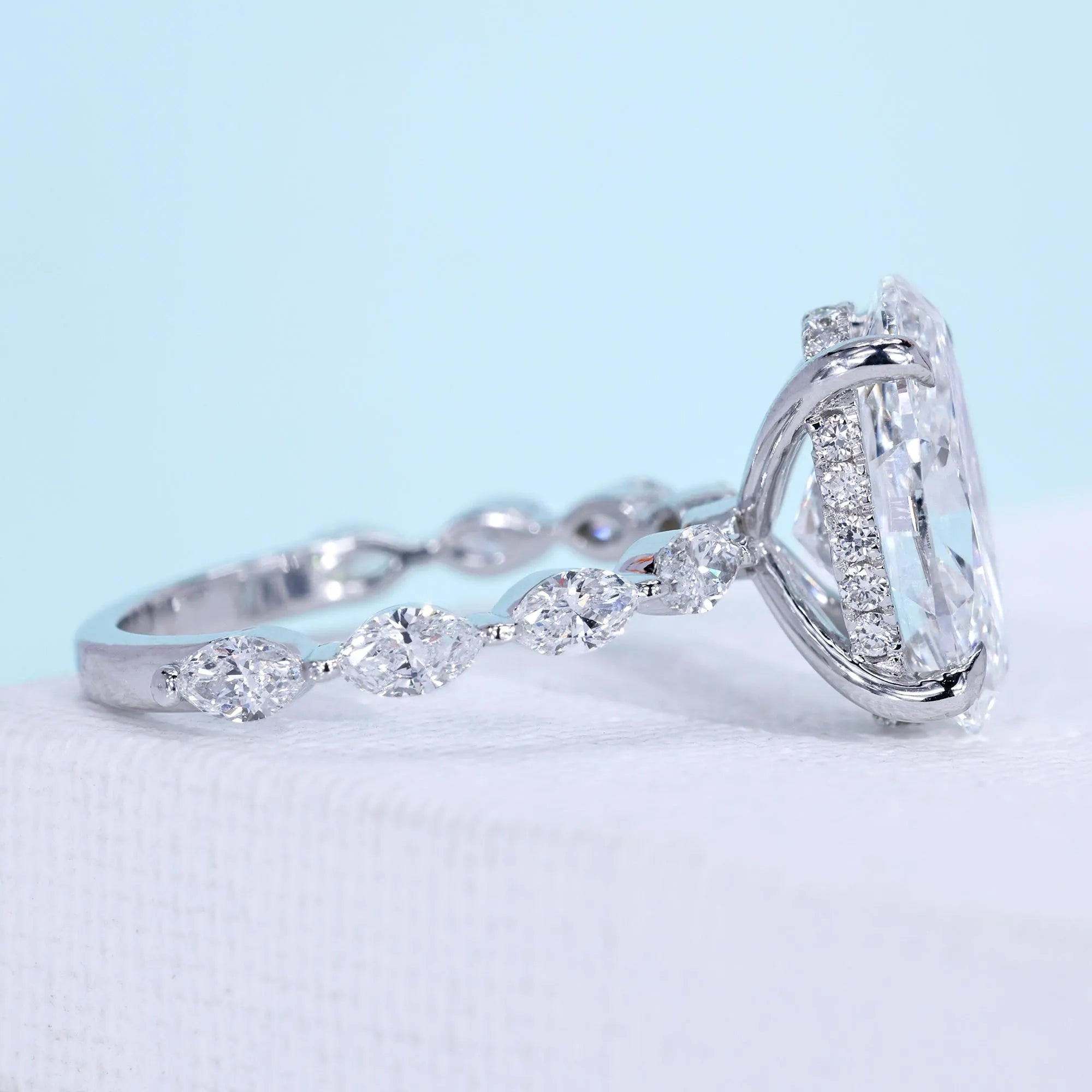 Oval lab grown diamond ring with marquise side stone accents
