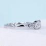 Emerald cut east west engagement ring with three stone diamond design
