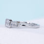 Lab grown emerald cut diamond ring with cathedral bezel setting
