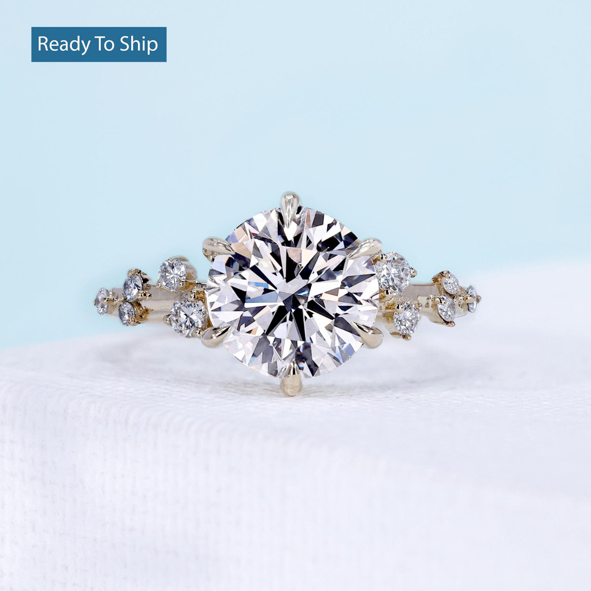 6 prong engagement ring with round cut diamond and side stones
