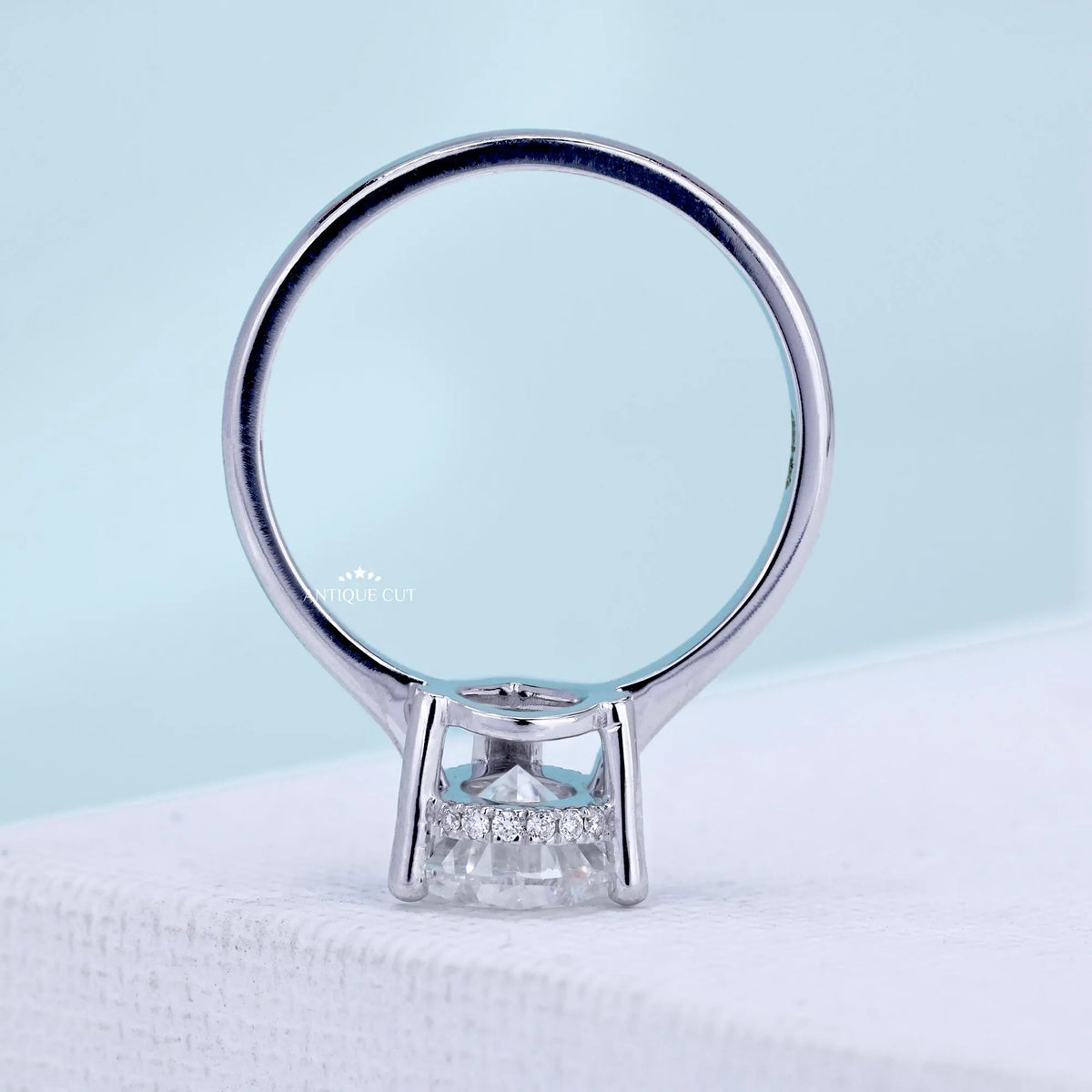 Hidden halo pear engagement ring with secure V prong setting
