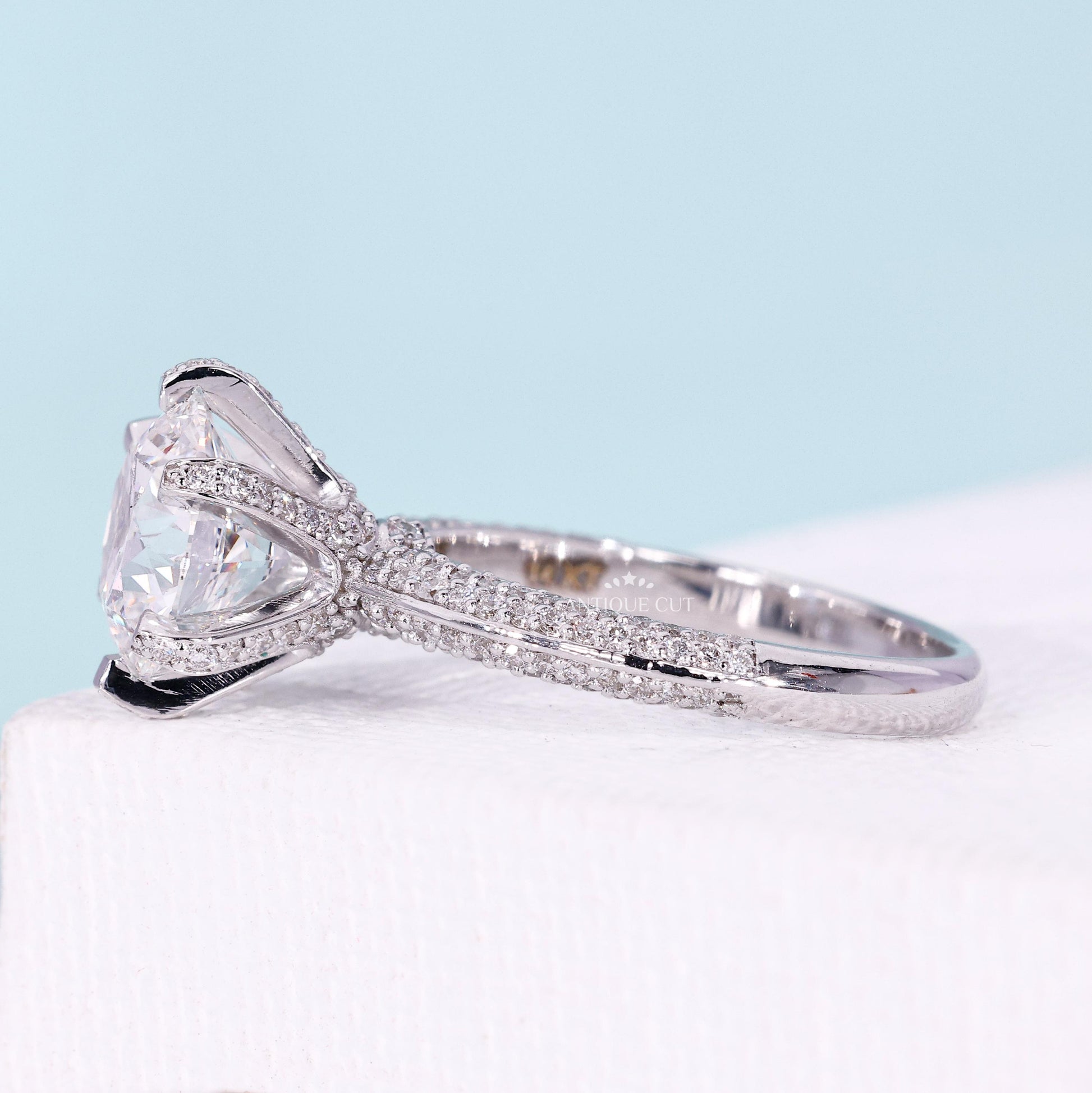 Round cut pavé band ring with three row diamond design
