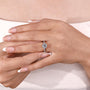 Women’s floral halo ring with twisted band engagement design
