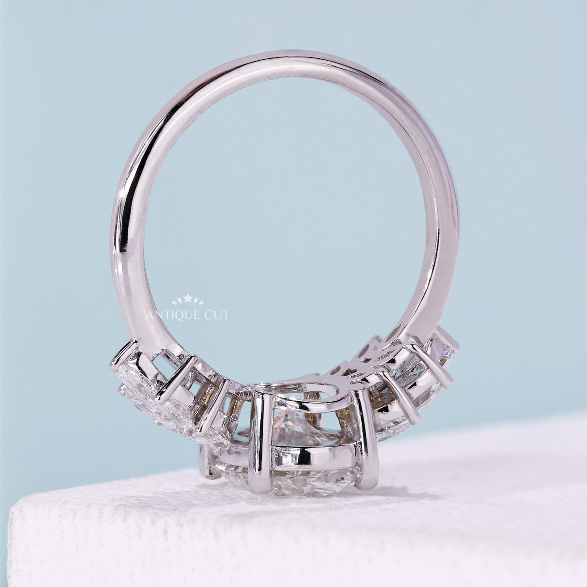 Oval cut diamond ring with elegant marquise side stone details
