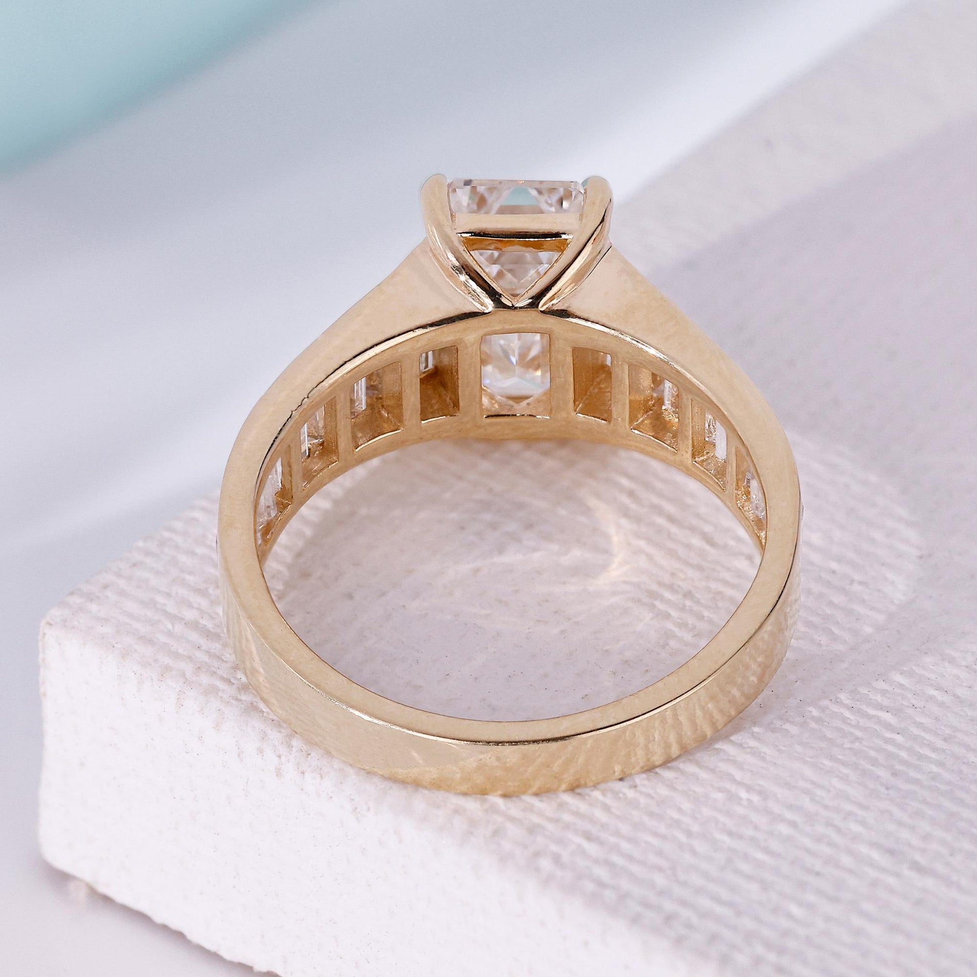 Three stone emerald cut engagement ring design
