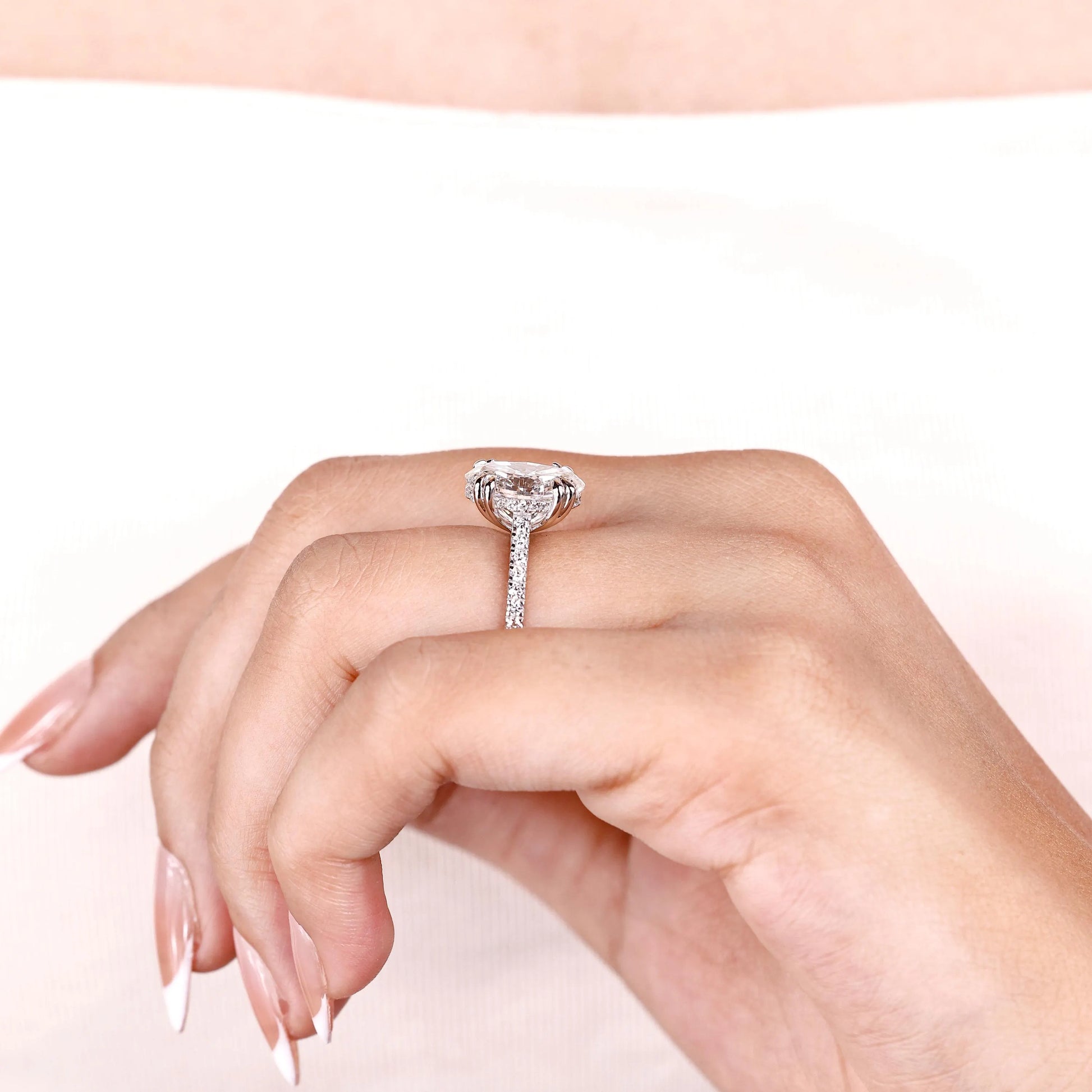 White gold oval engagement ring with secure double claw prongs