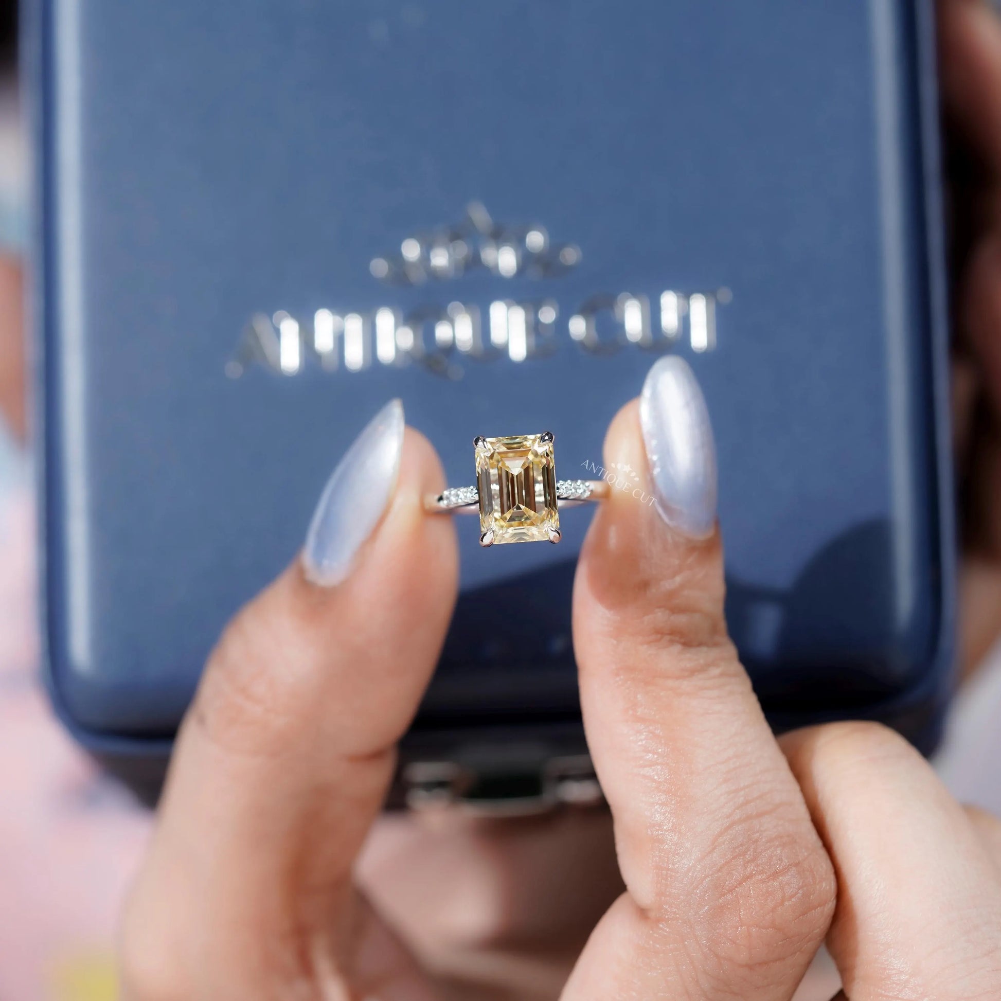 Elegant white gold engagement ring with Yellow Emerald Cut Diamond.