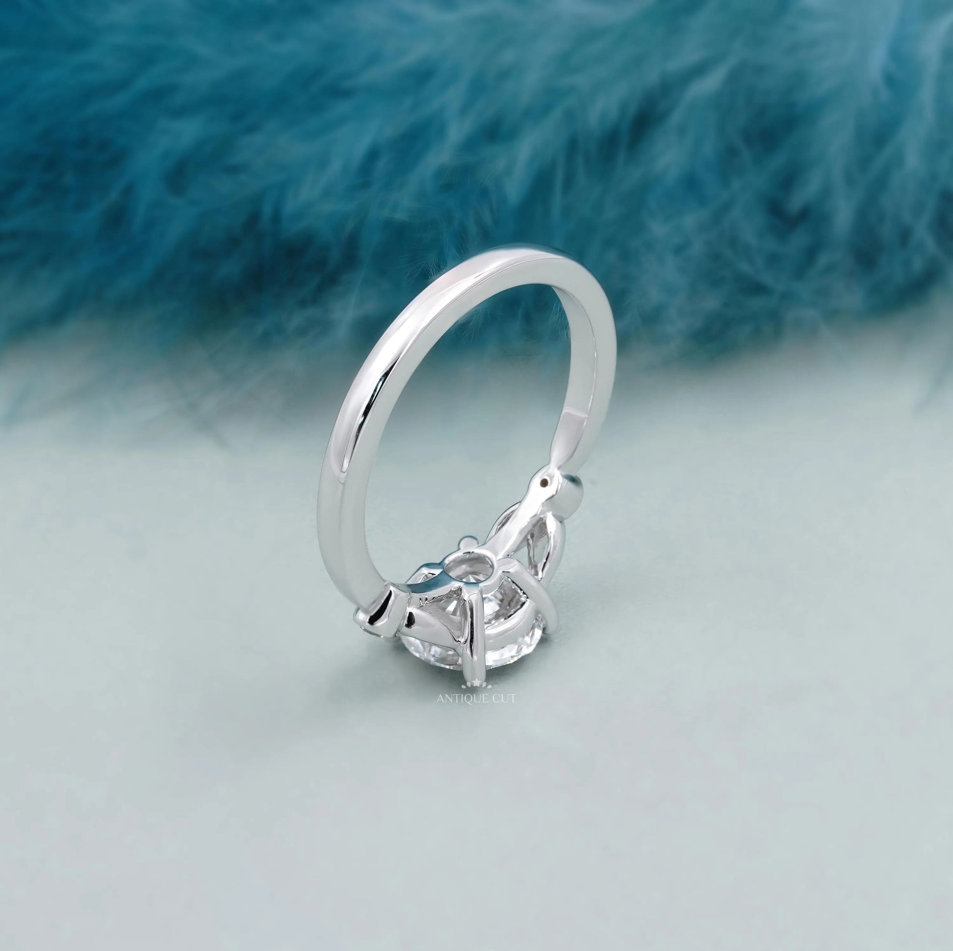Elegant round solitaire diamond ring with leaf accents