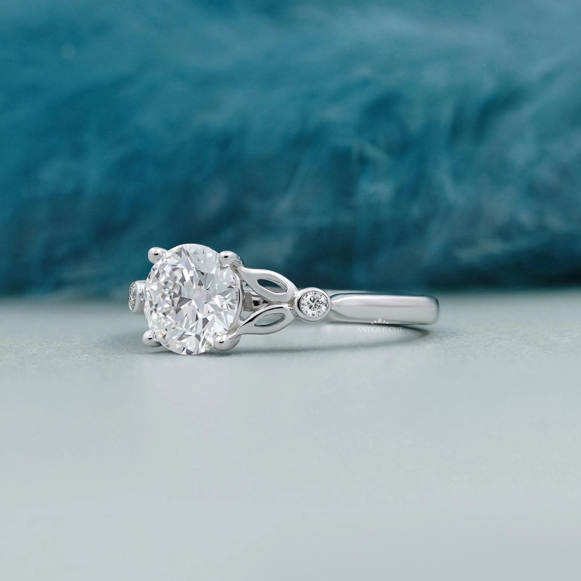 White gold round diamond ring with botanical leaf details