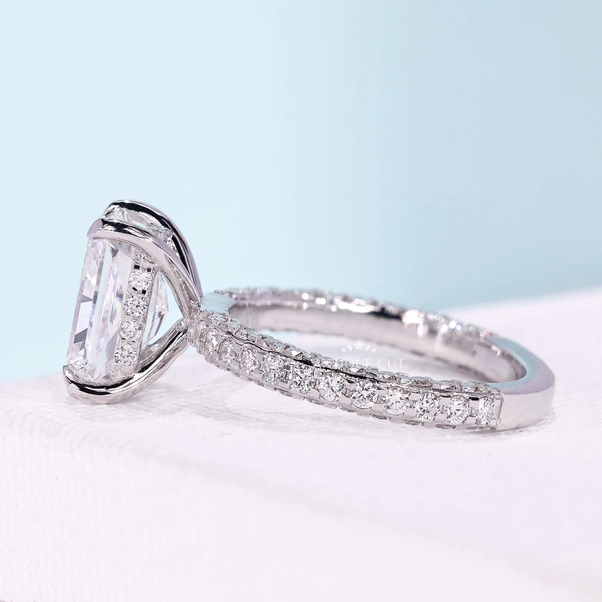 Three row pavé engagement ring with radiant center stone
