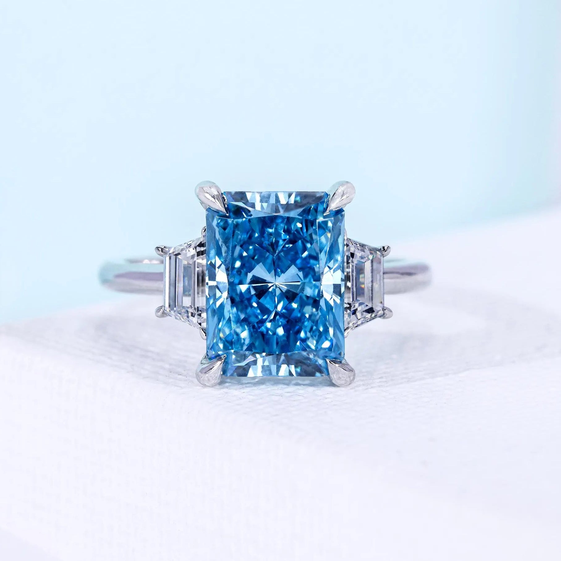 Fancy Blue Radiant Cut Three Stone Lab Grown Diamond Engagement Ring with Tapered Baguette Side Stones