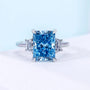 Fancy Blue Radiant Cut Three Stone Lab Grown Diamond Engagement Ring with Tapered Baguette Side Stones