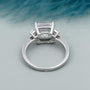 Emerald cut diamond ring with tapered step cut side stones