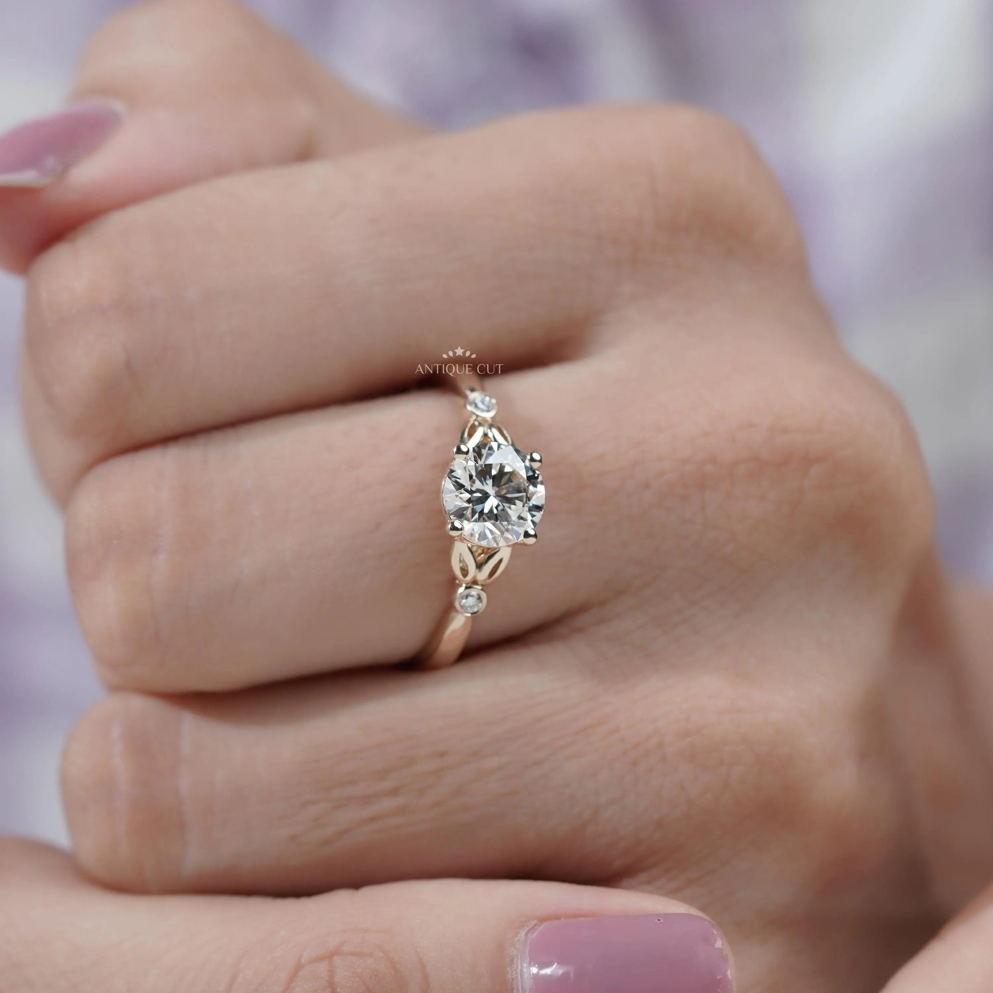 Round diamond solitaire ring with decorative side details