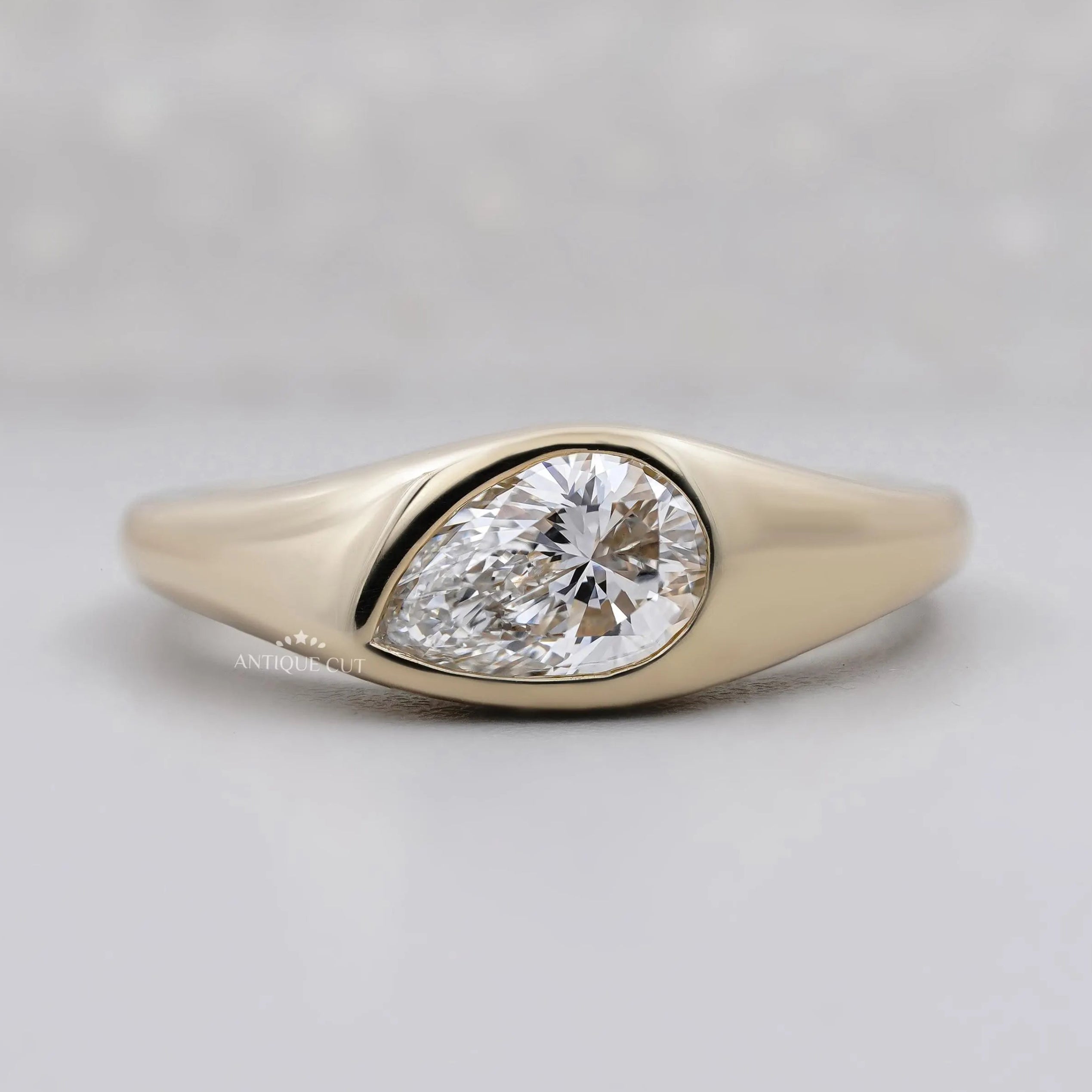 Pear cut lab grown diamond signet ring in yellow gold