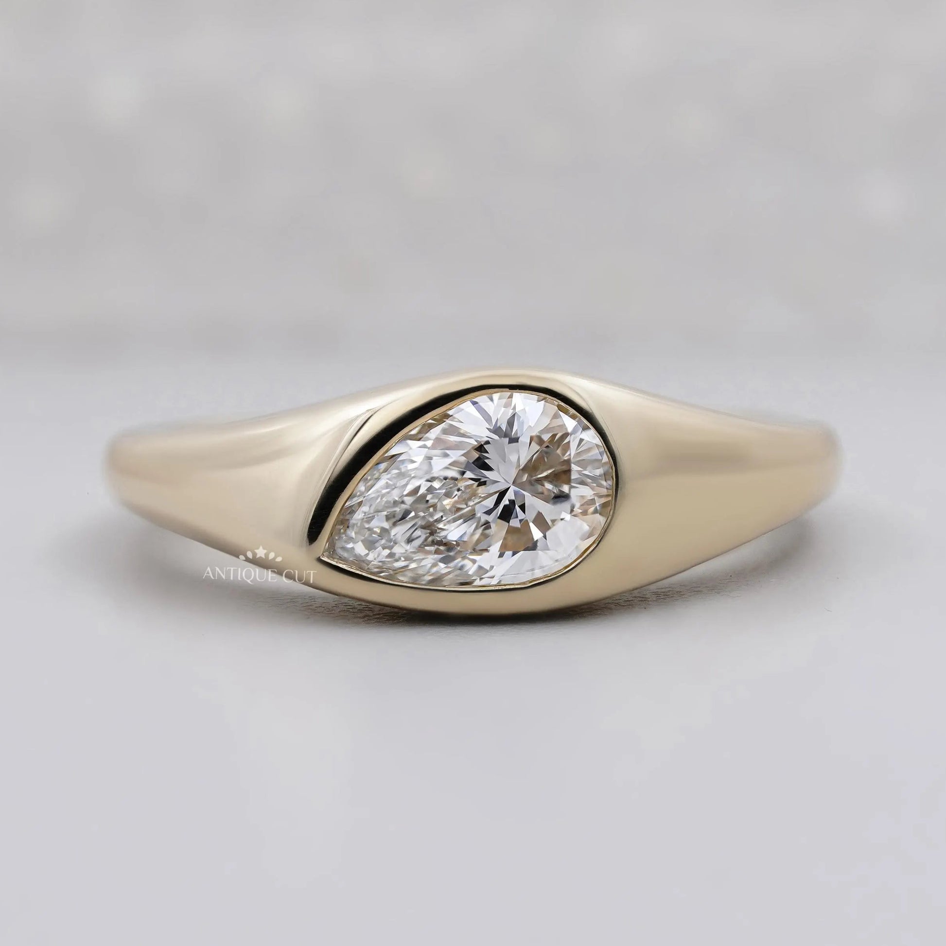 Pear cut lab grown diamond signet ring in yellow gold