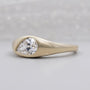 Yellow gold signet ring with sideways pear shaped diamond