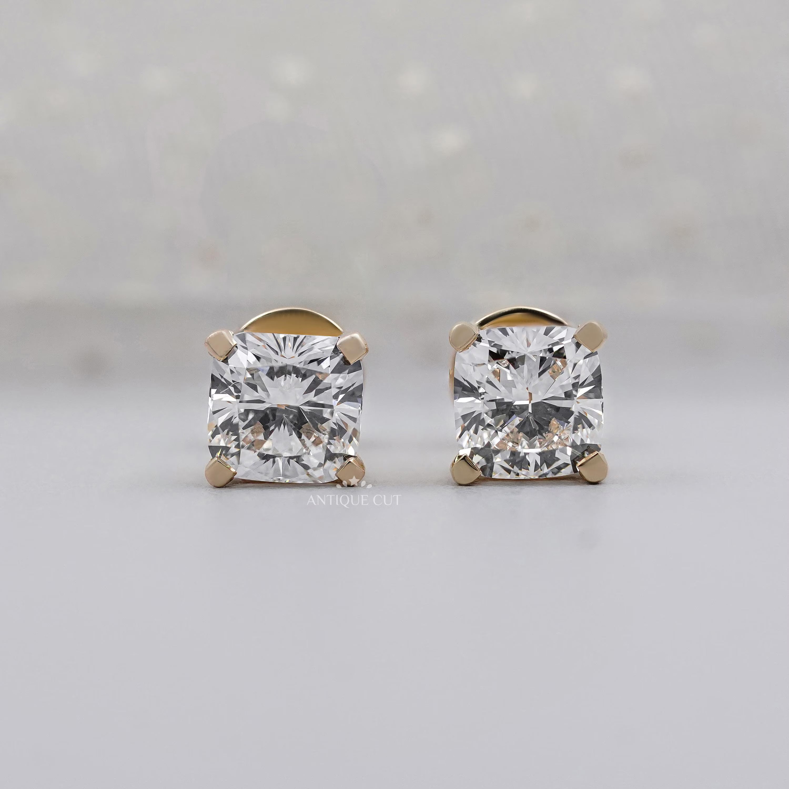 Yellow gold cushion cut diamond earrings with 4 prong setting