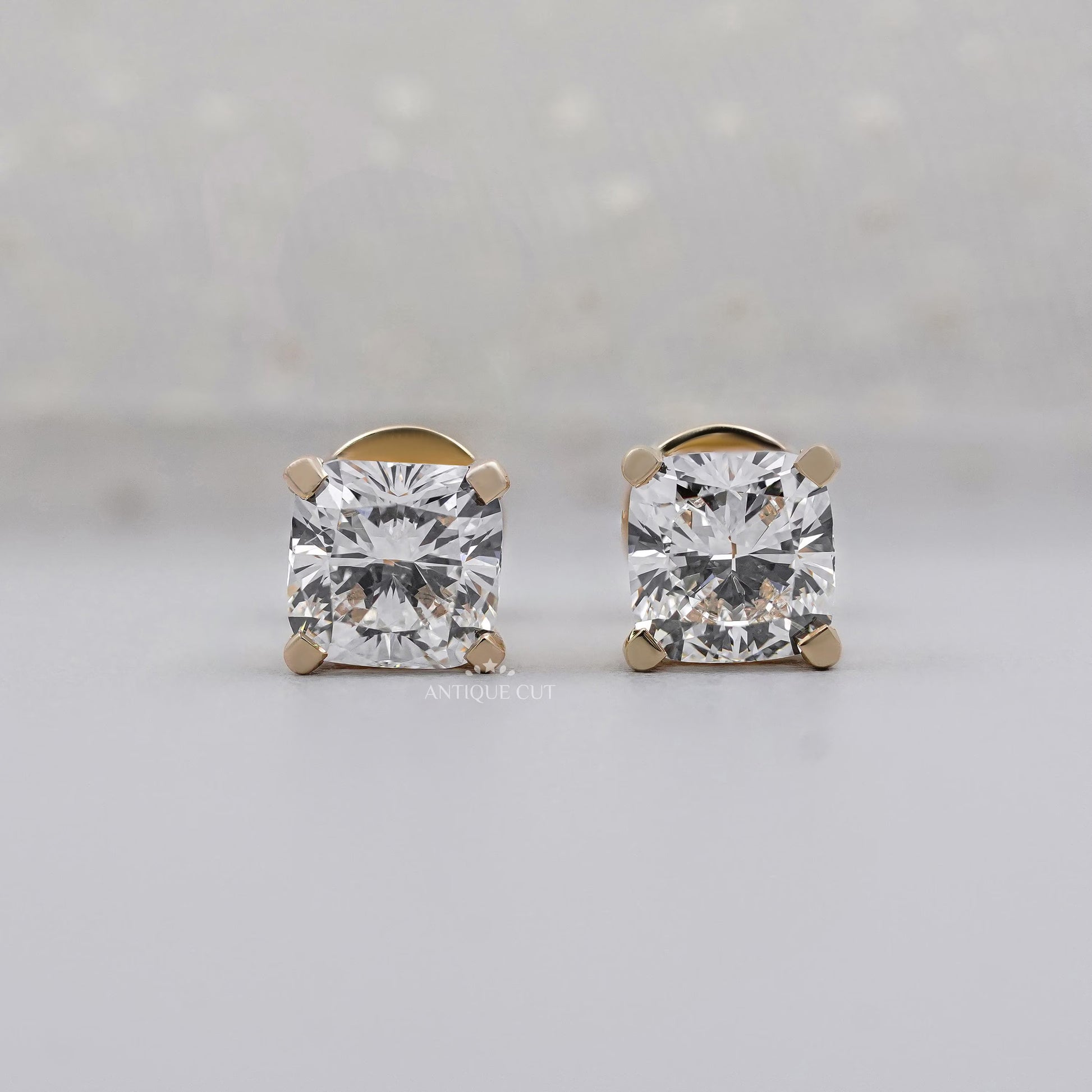 Yellow gold cushion cut diamond earrings with 4 prong setting