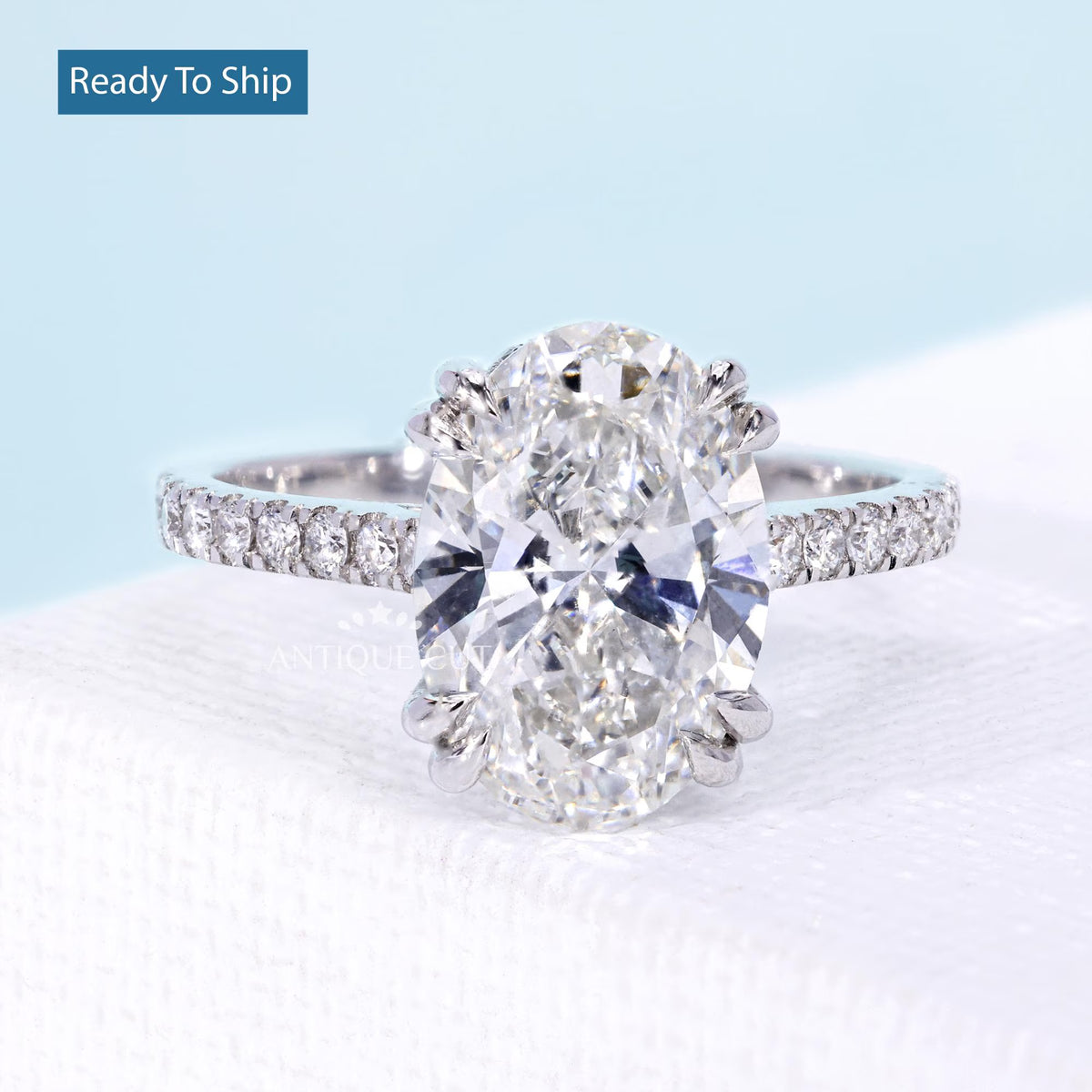 Oval cut diamond engagement ring with marquise floral side stones in white gold
