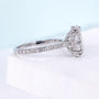 White gold oval diamond engagement ring featuring floral marquise side stones
