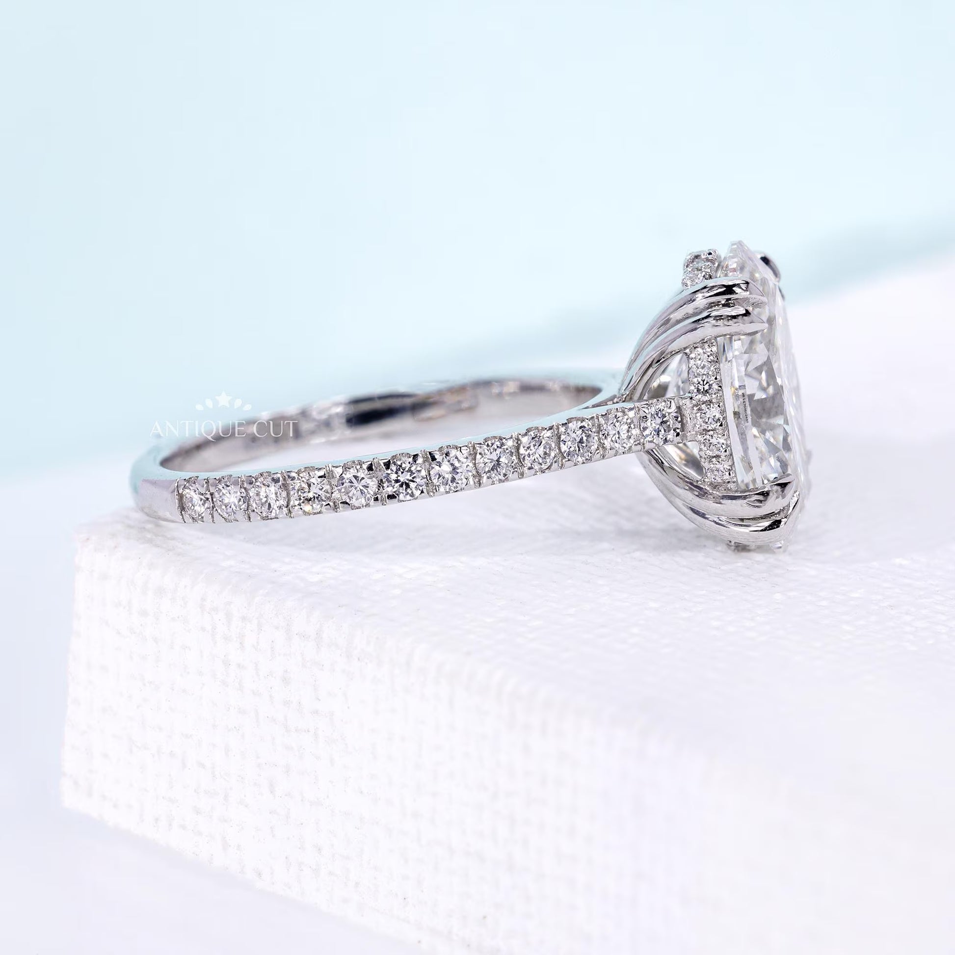 White gold oval diamond engagement ring featuring floral marquise side stones
