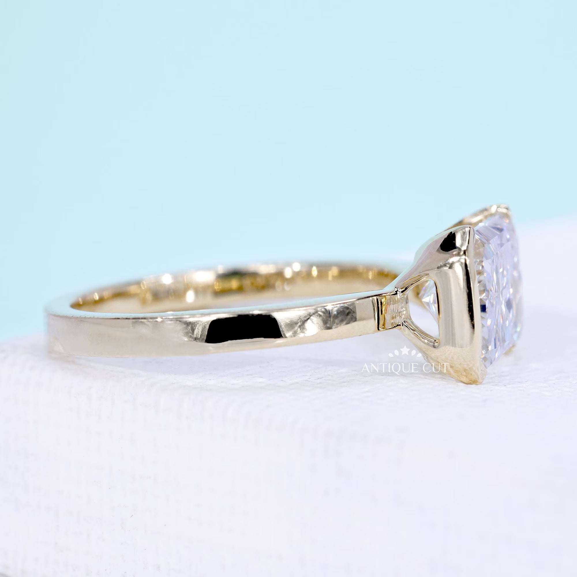 Yellow gold east west engagement ring with radiant cut lab grown diamond
