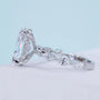 Oval diamond ring with 4 claw prong setting and marquise pavé band
