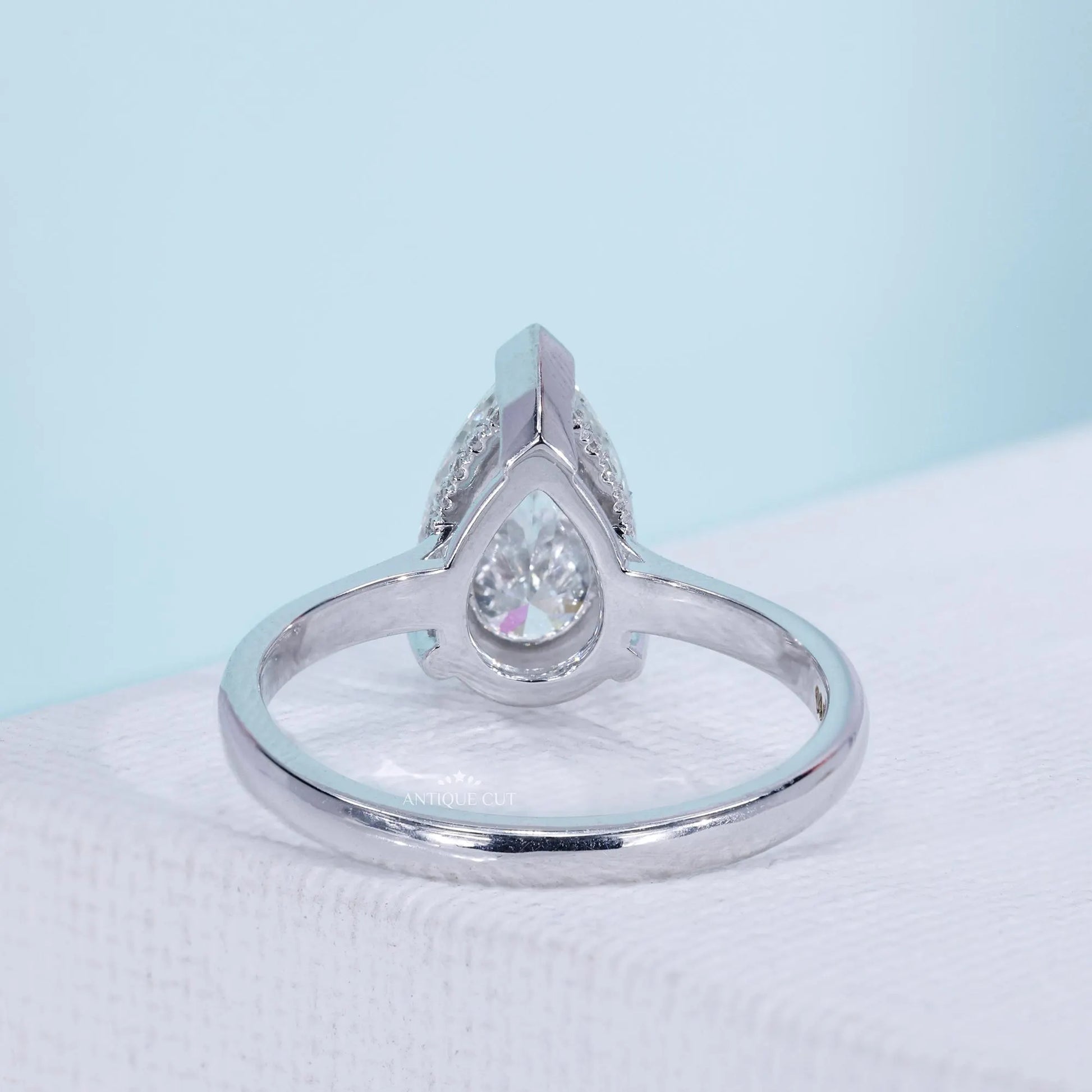 Antiquecut pear diamond engagement ring with solitaire design
