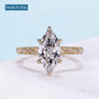 Vintage marquise engagement ring with hidden halo and yellow gold setting
