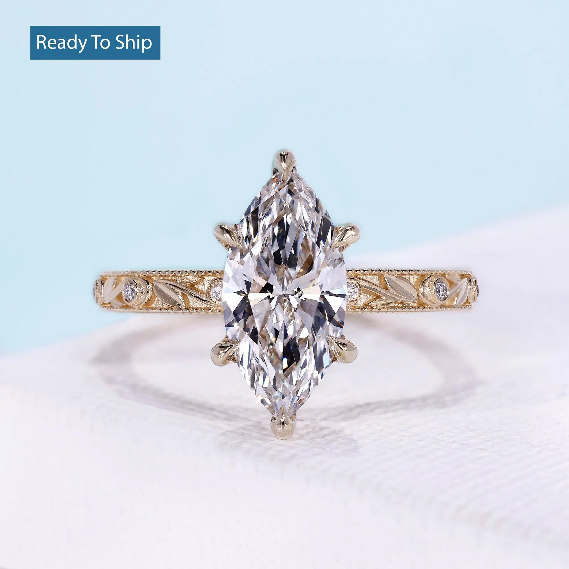 Vintage marquise engagement ring with hidden halo and yellow gold setting
