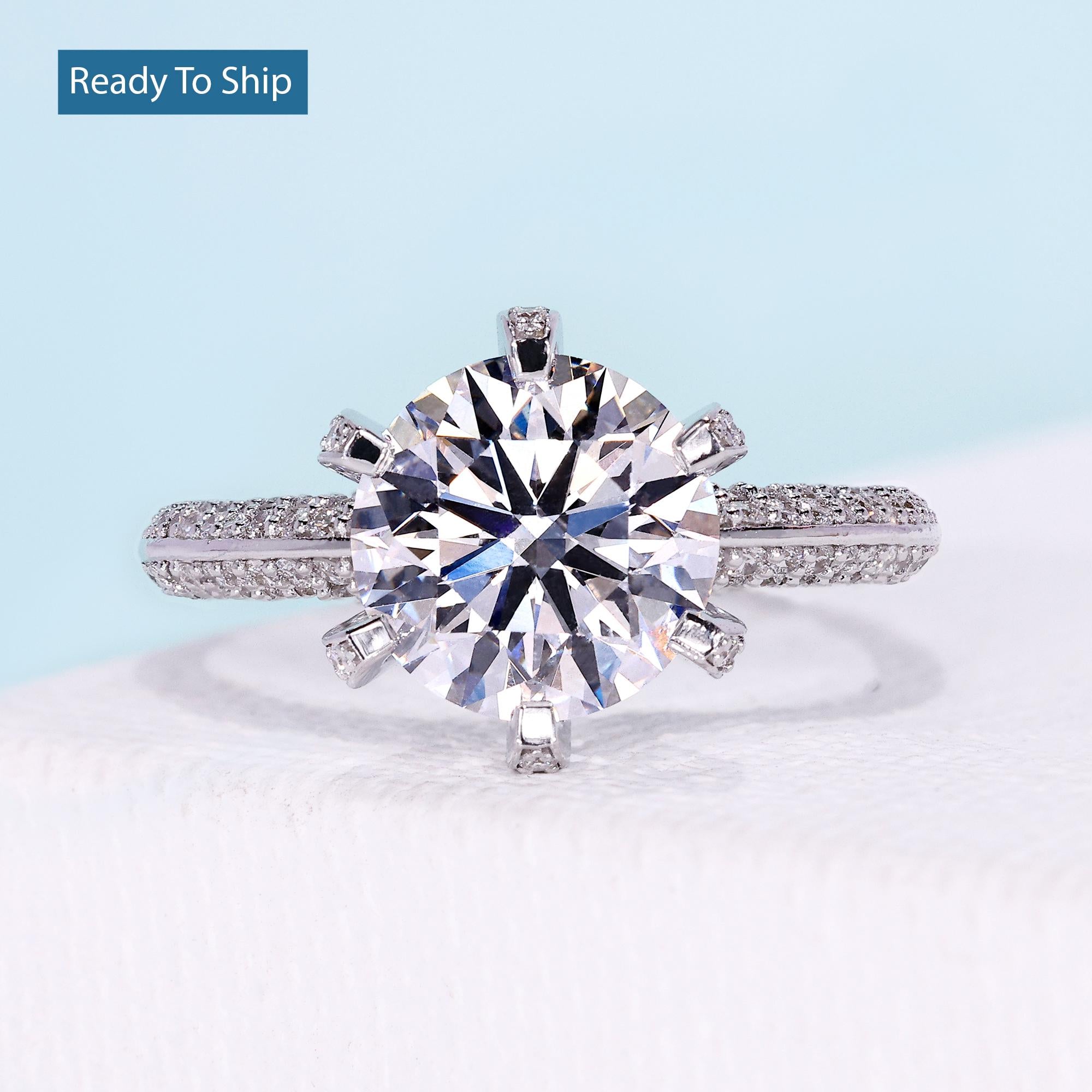 Round brilliant diamond ring with three row pave diamond band in white gold

