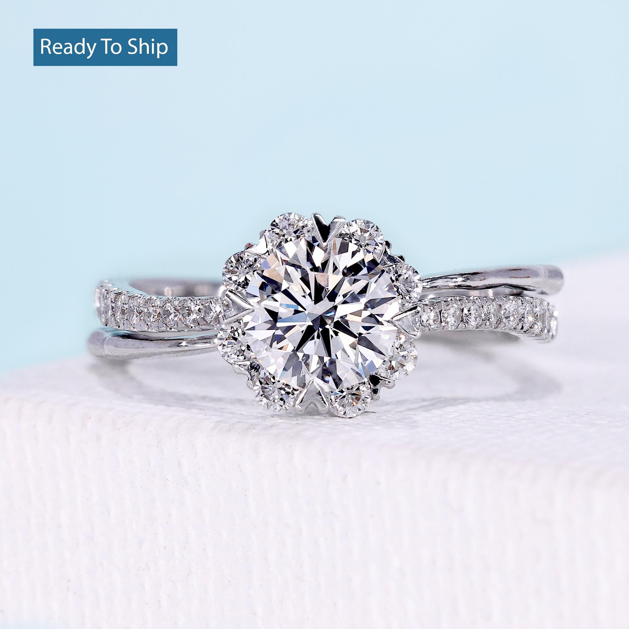 Floral halo engagement ring with round cut diamond and twisted pavé band
