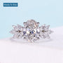 Oval cut diamond engagement ring with marquise floral side stones in white gold
