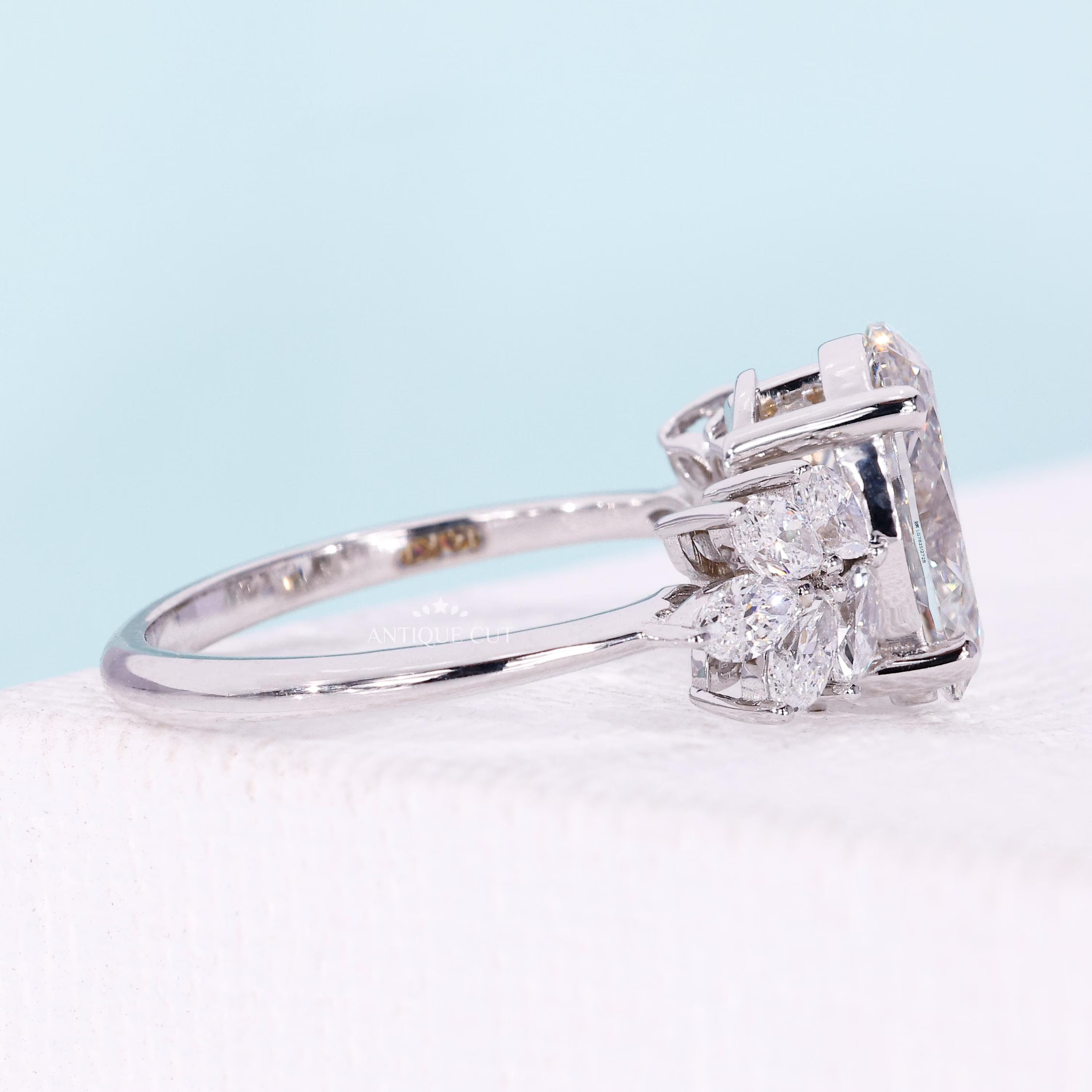 White gold oval diamond engagement ring featuring floral marquise side stones
