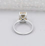 White gold Yellow Emerald Cut Diamond ring with round side stones.