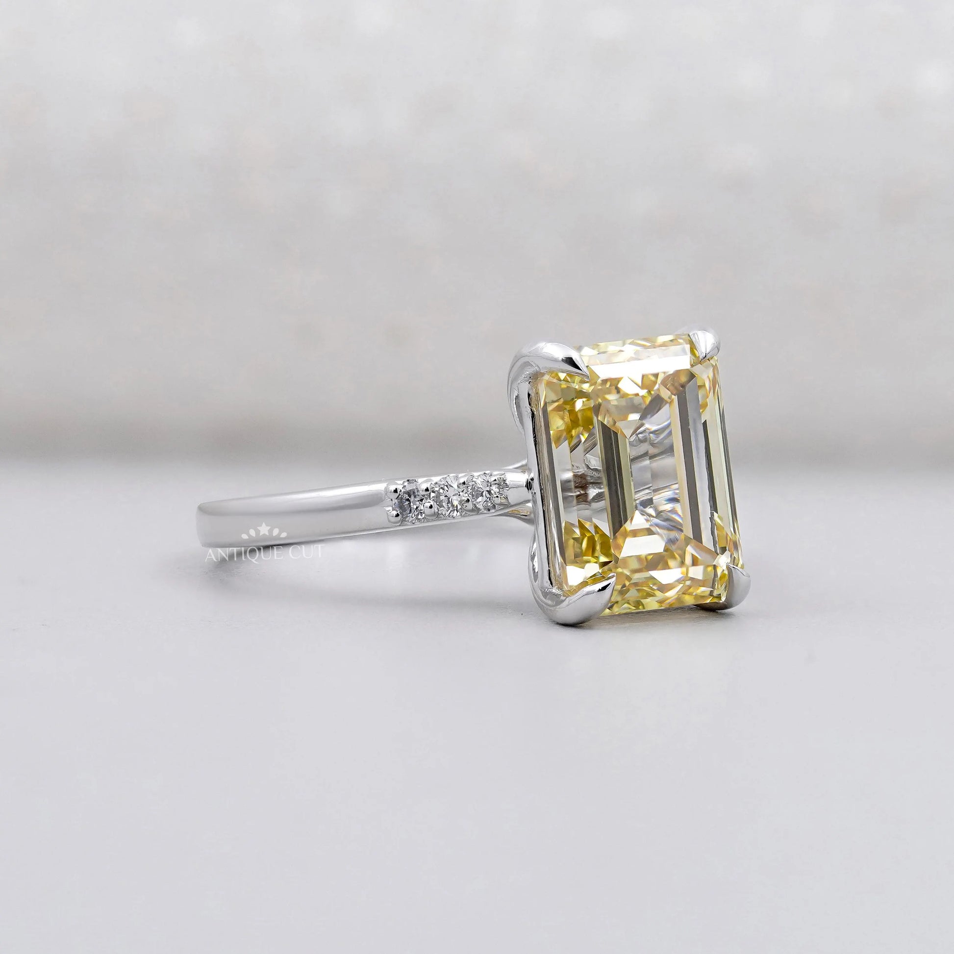 IGI Certified Yellow Emerald Cut Lab Grown Diamond Ring in white gold.