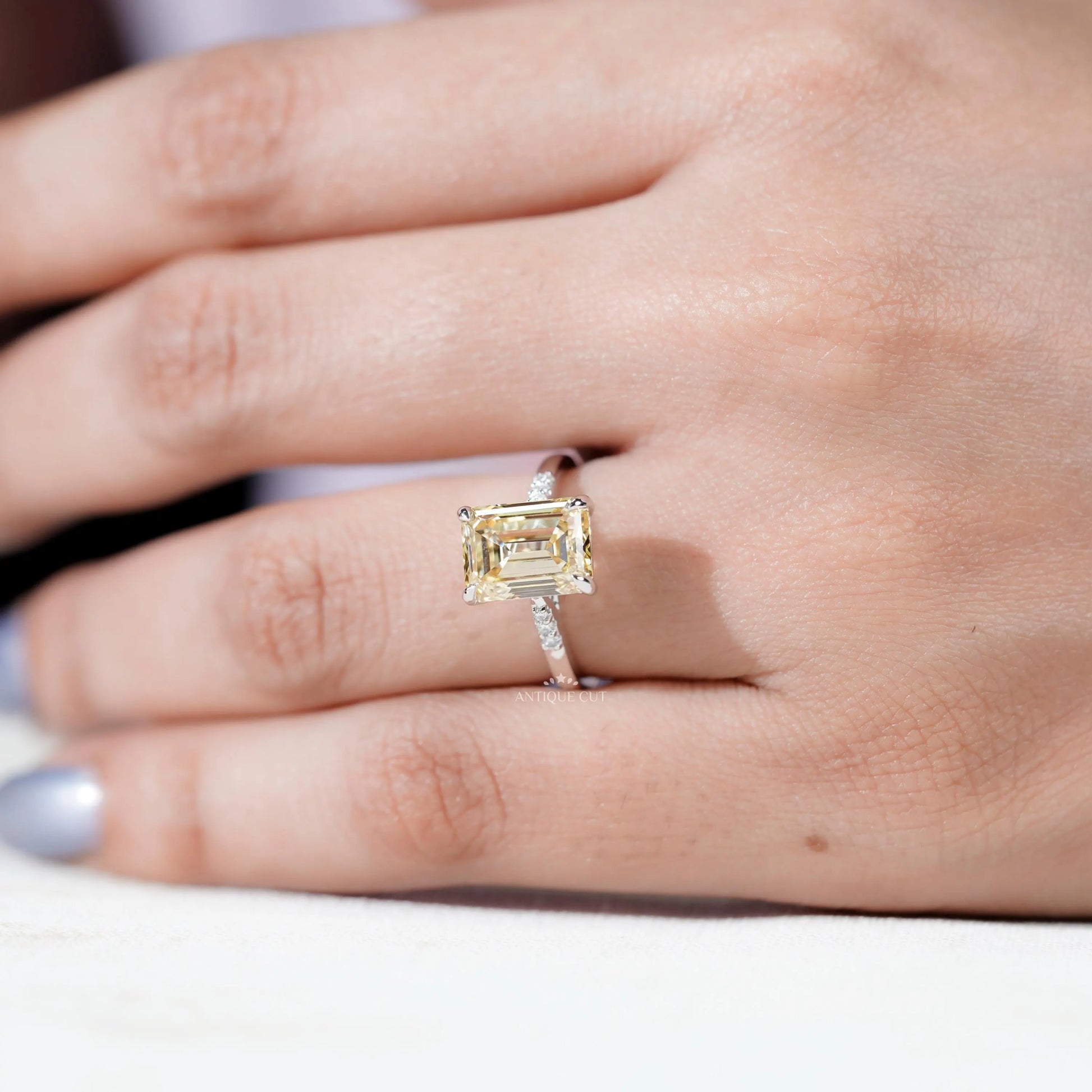 IGI Certified Yellow Emerald Cut Diamond ring with side stones.