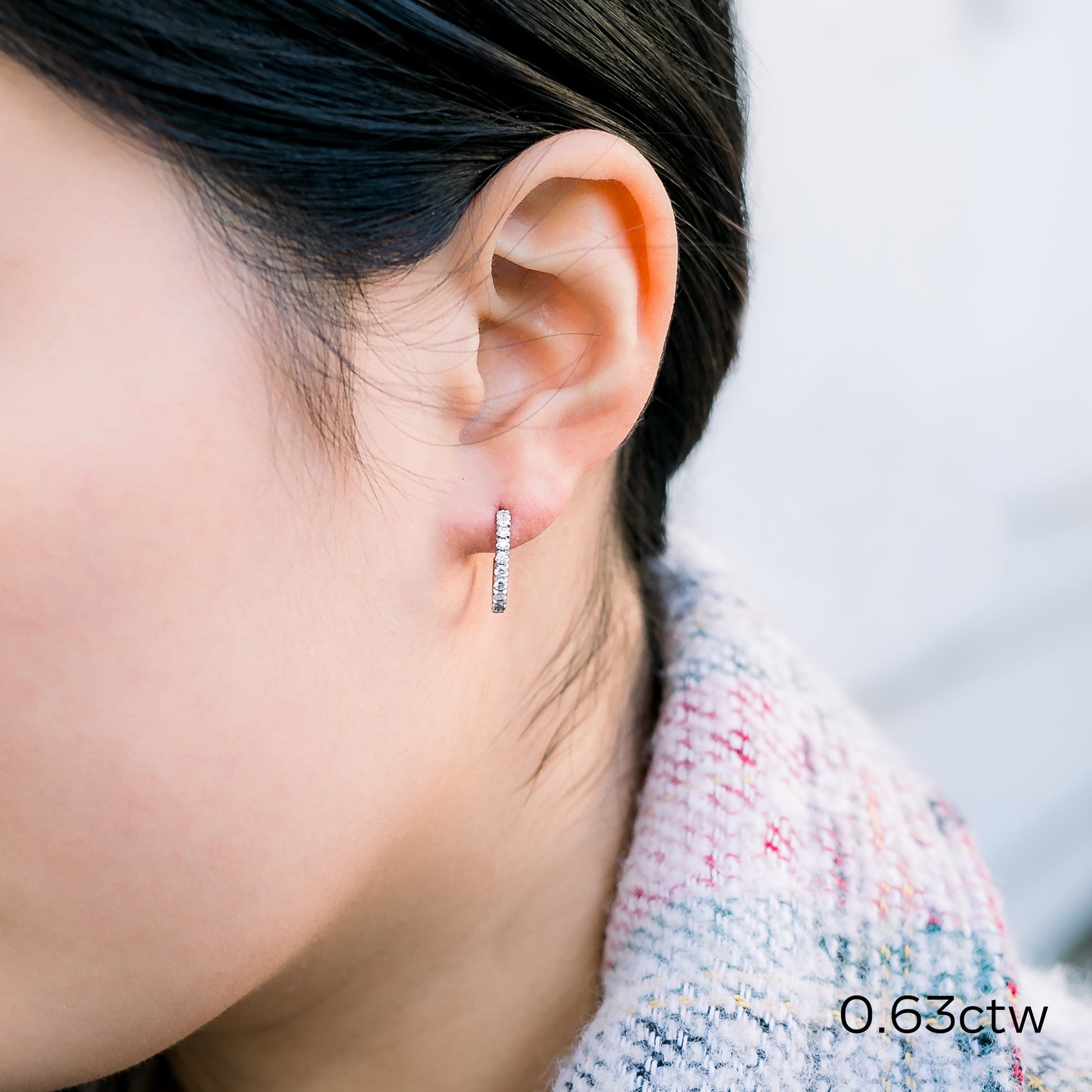 Earring with diamonds on a woman.