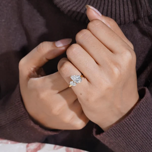 Pear shaped diamond toi et moi engagement ring in yellow gold