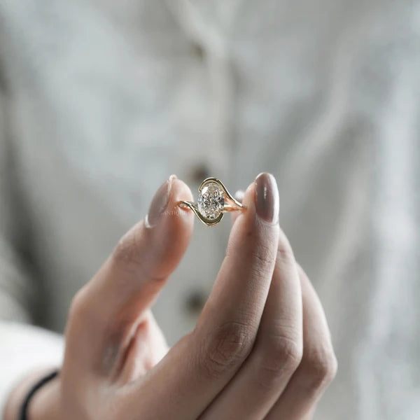 Oval cut diamond engagement ring with bypass setting