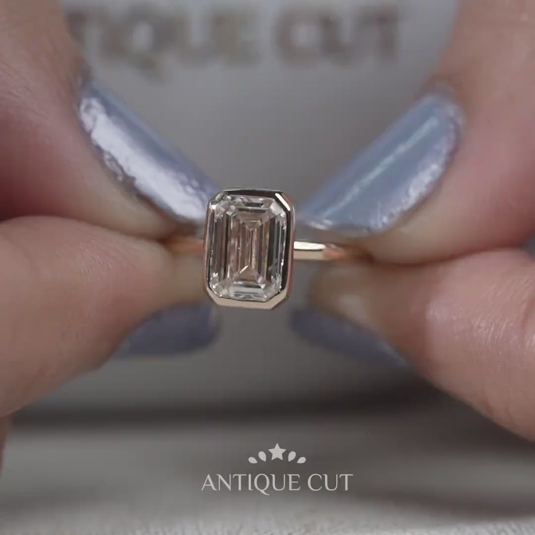 Emerald cut solitaire engagement ring in yellow gold
